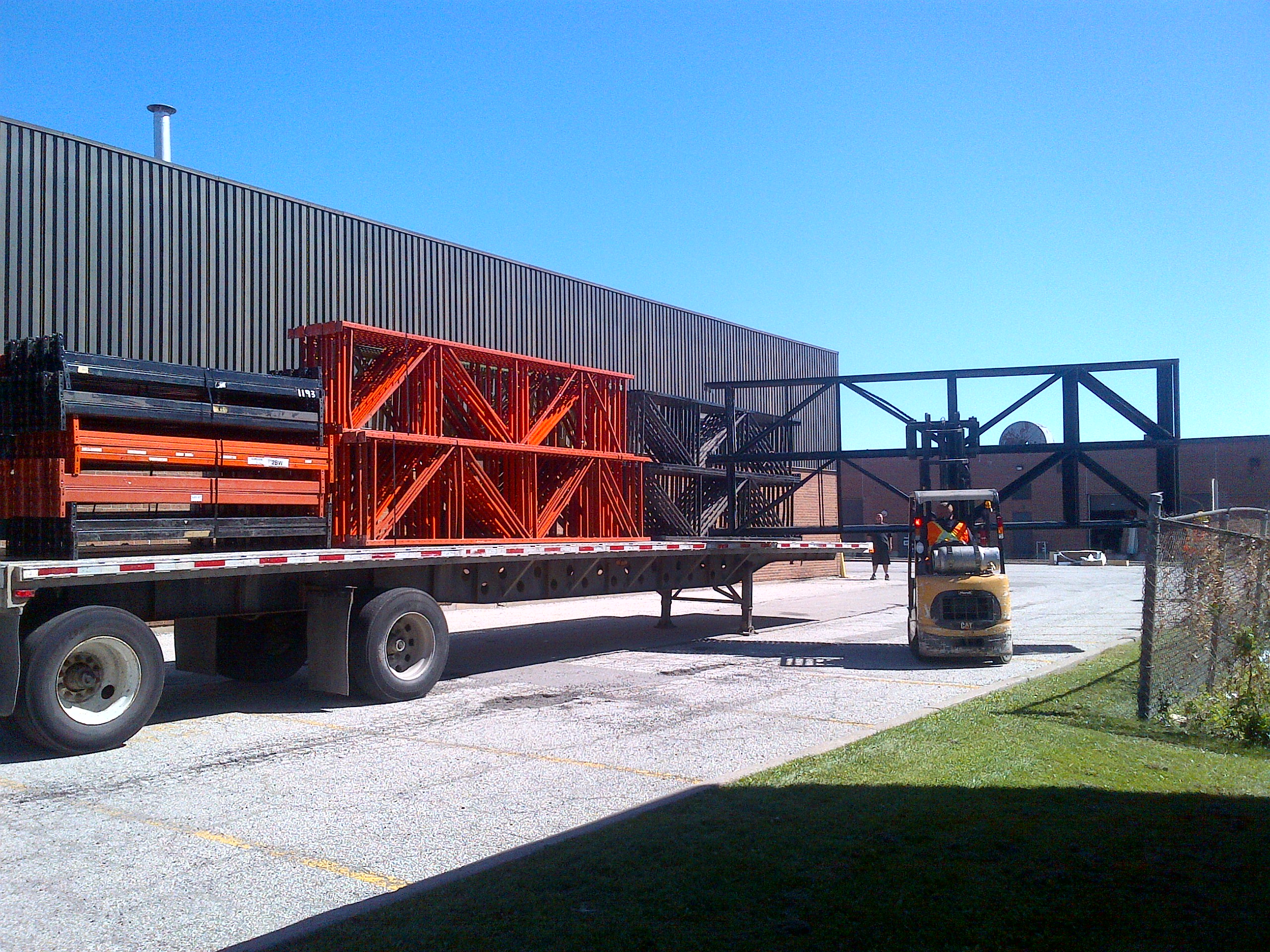 unloading truck full of pallet rack